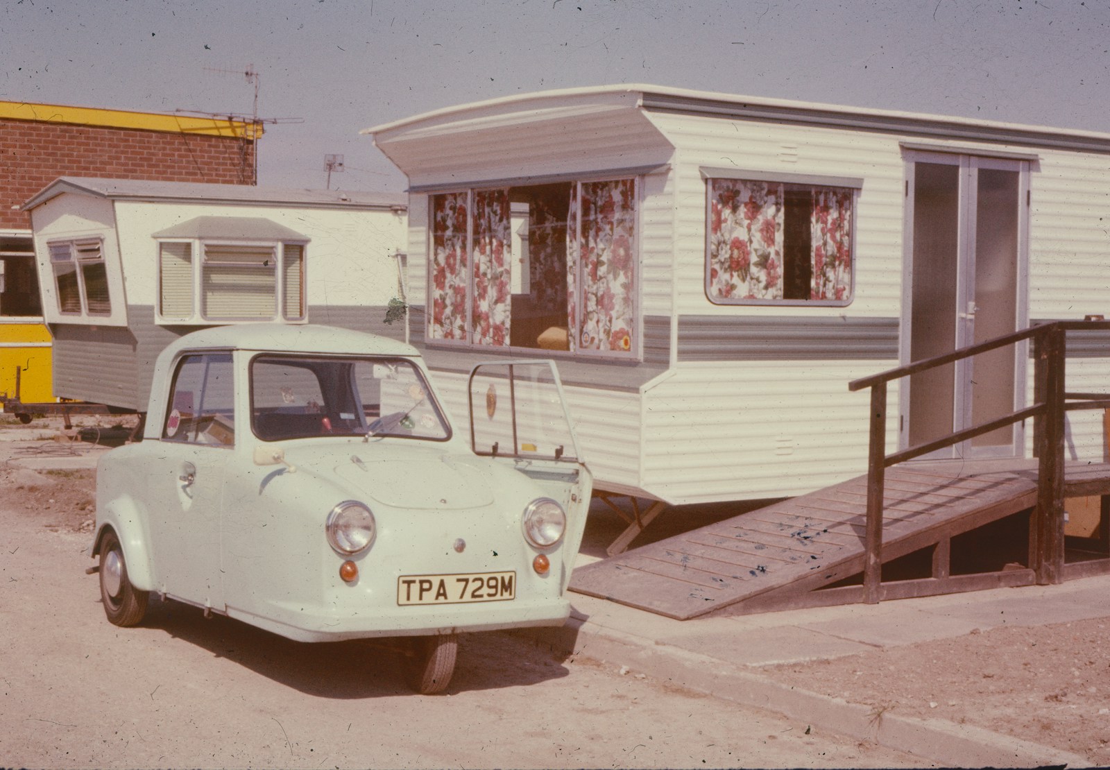 an old car parked in front of a house