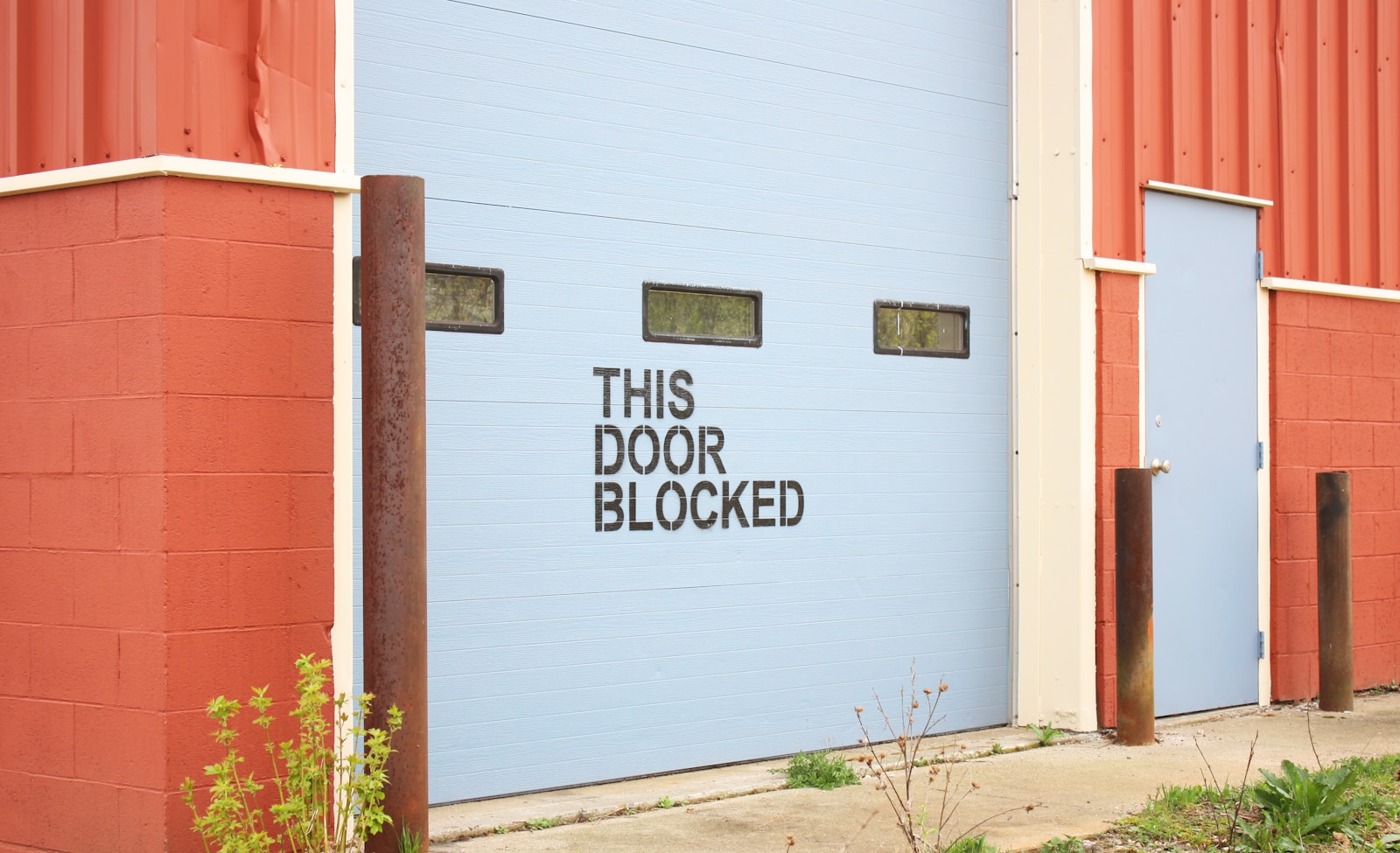 white and brown wooden wall with white and black wooden signage