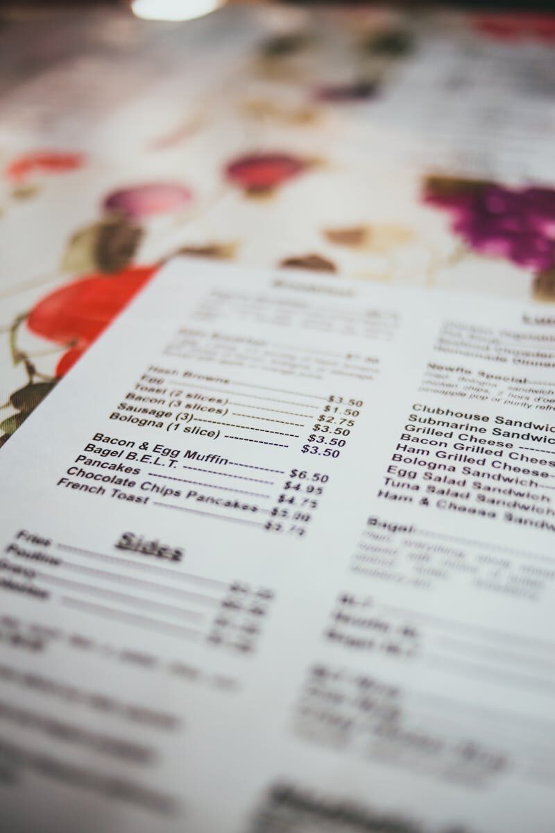 Detailed close-up of a colorful restaurant menu highlighting text and prices.