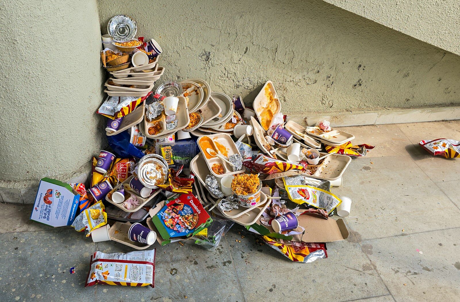 Pile of discarded fast food trays and trash.
