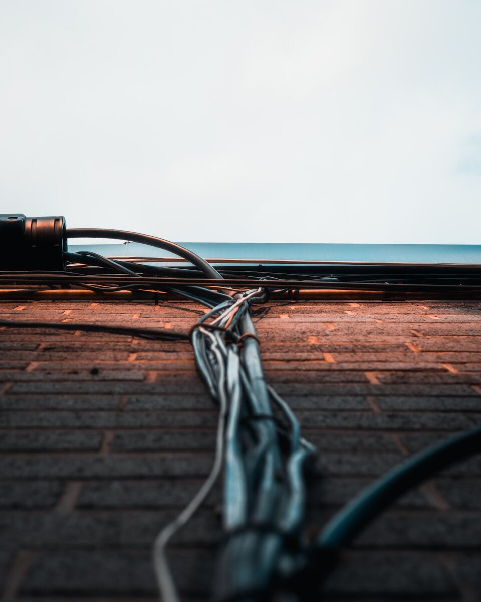 a wire laying on the ground next to the ocean