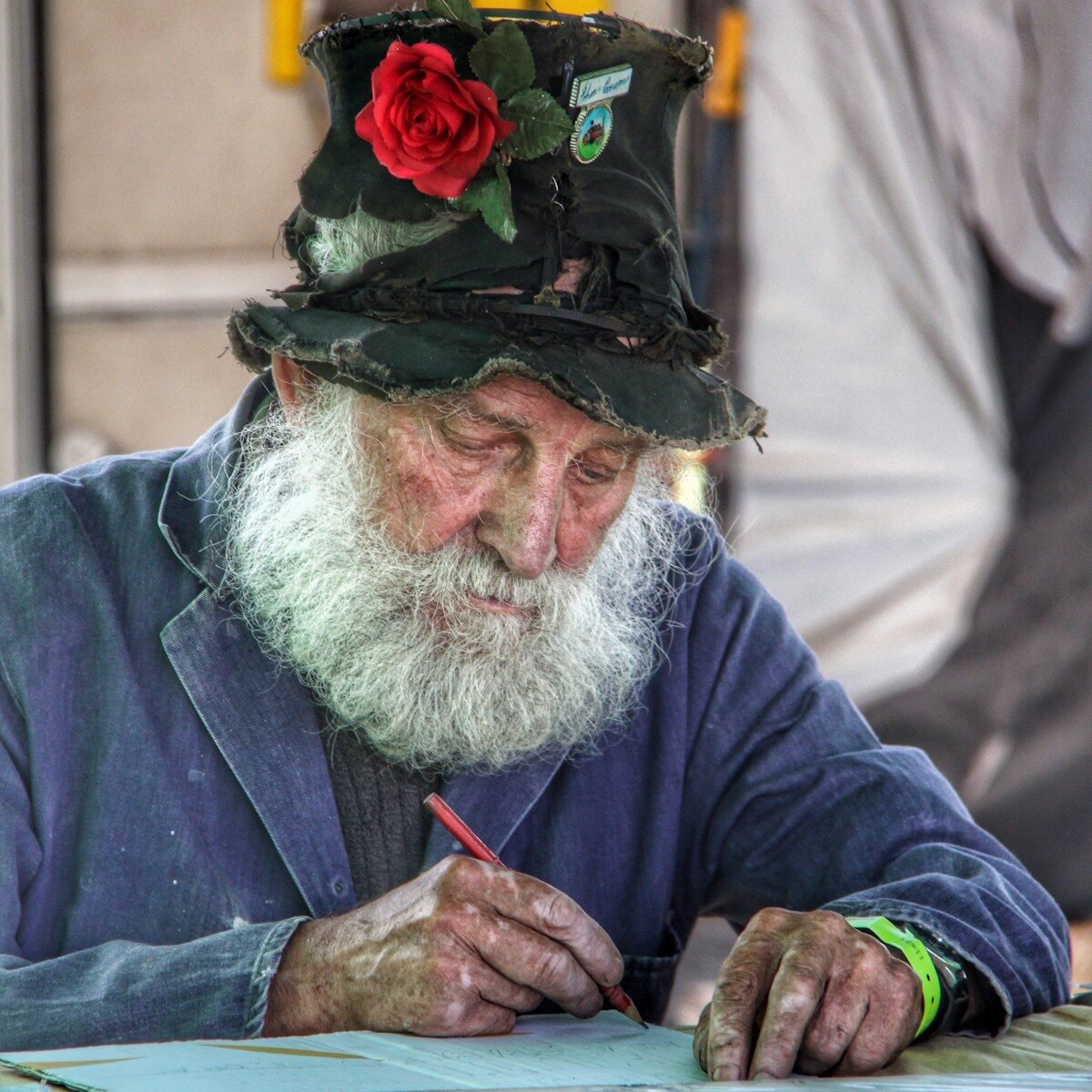shallow focus photo of man writing on printing paper
